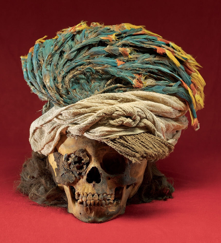 a headdress on a 600-year-old skull of a sacrificed male child from Peru