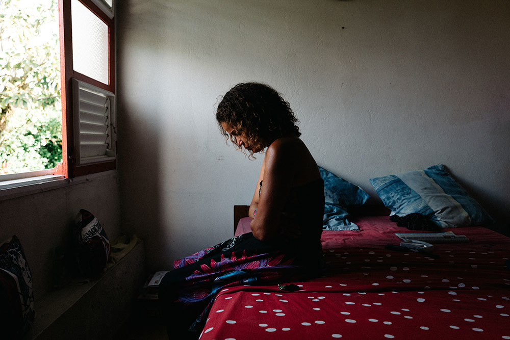 Nathaly sitting on a bed