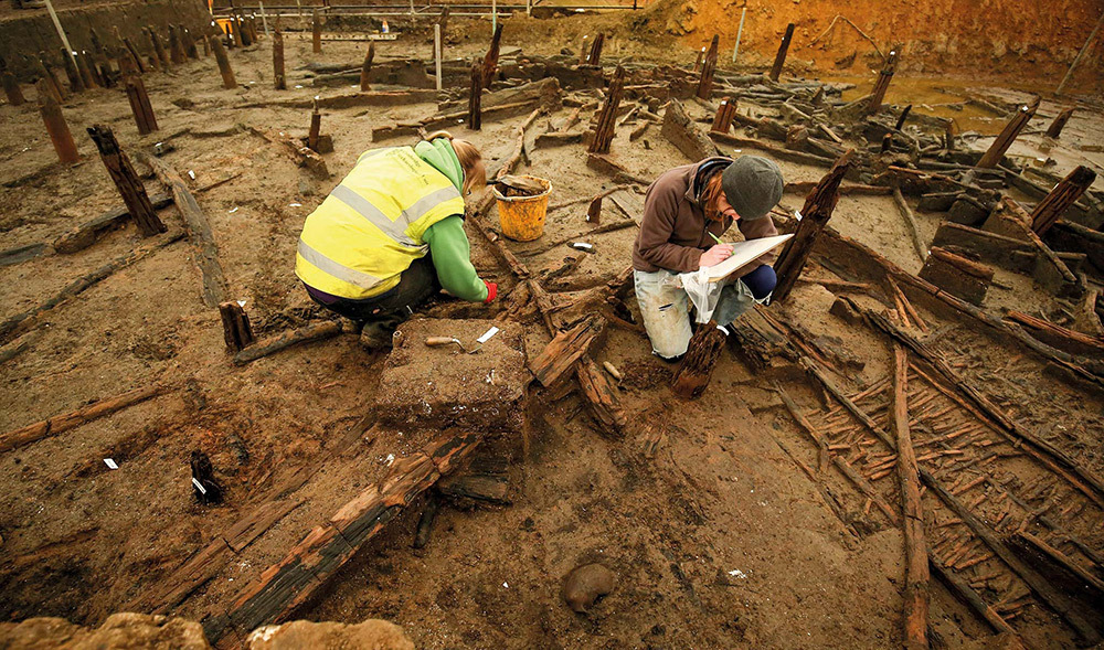 Archaeologists excavate the ancient river course at Must Farm.