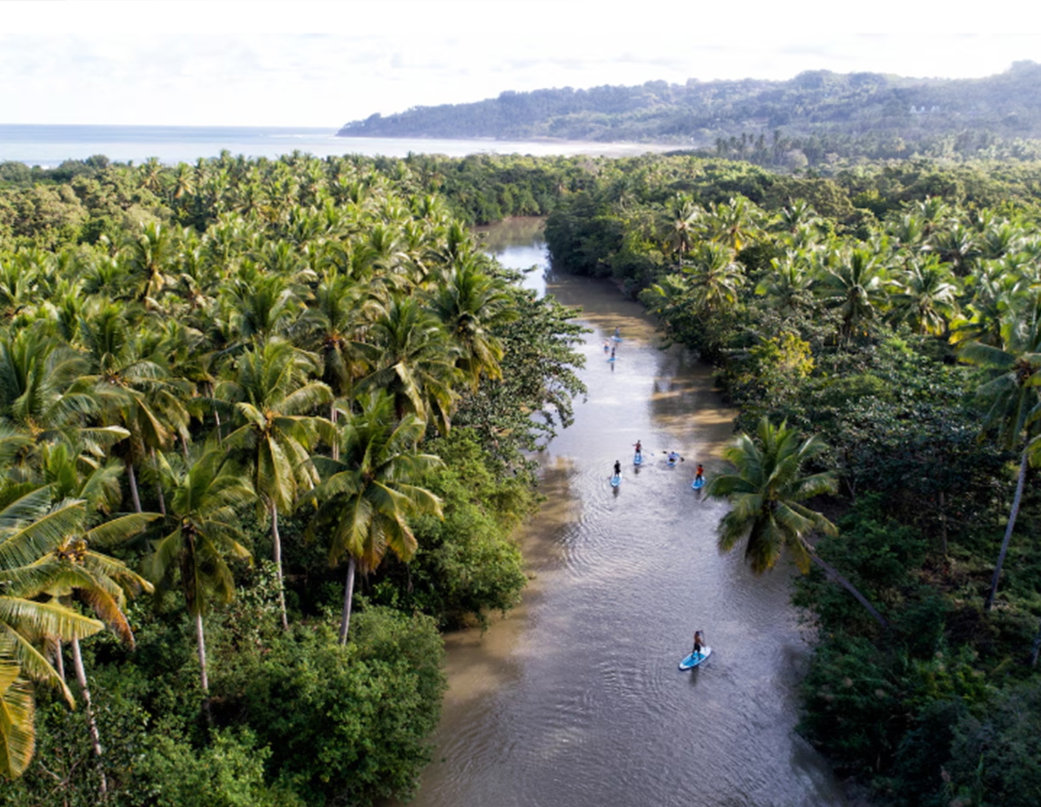 Standup paddleboarders glide down the Wanukaka River