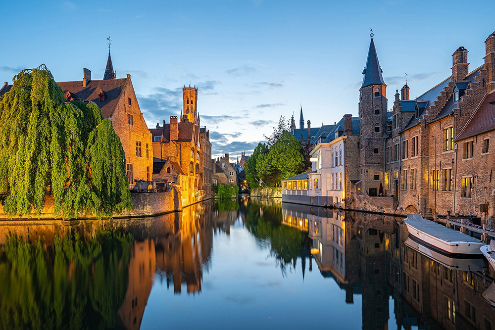 A view across Brugge-Zeebrugge Canal to the Belfry of Bruges in the Belgian city of Bruges