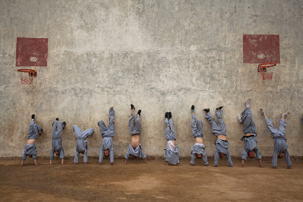 Martial arts students at the Shaolin Temple Tagou Martial Arts School in Dengfeng, China, practice a handstand for five minutes.