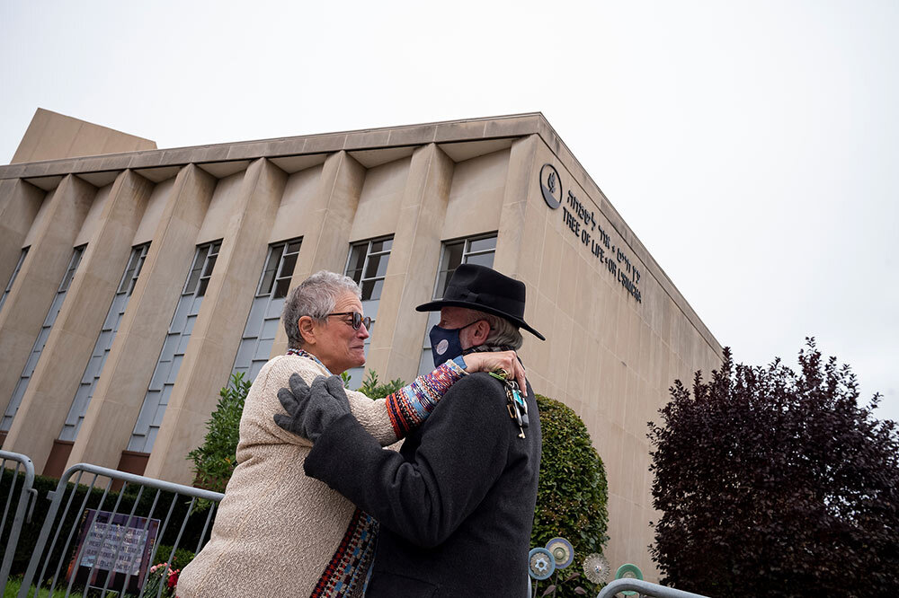 In this 2021 image, Rachel Dinkin Rosen, whose father was the former executive director of the synagogue, and Rabbi Jeffrey Myers, who managed to dodge bullets during the attack, greet each other.