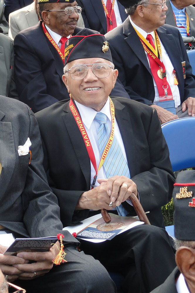 A picture of a man wearing a Marines cap.