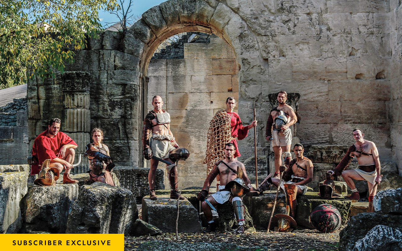 Gladiator reenactors pose amid Roman-era ruins in Arles, France. The equipment they use is based on archaeological finds.