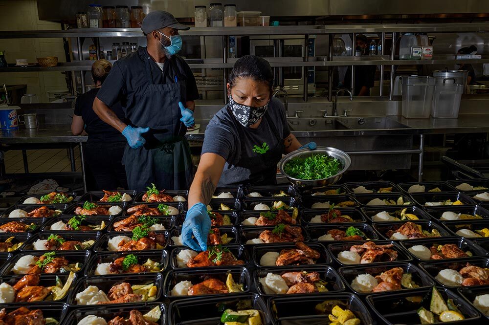 Volunteers help prepare meals to be distributed for free in Houston