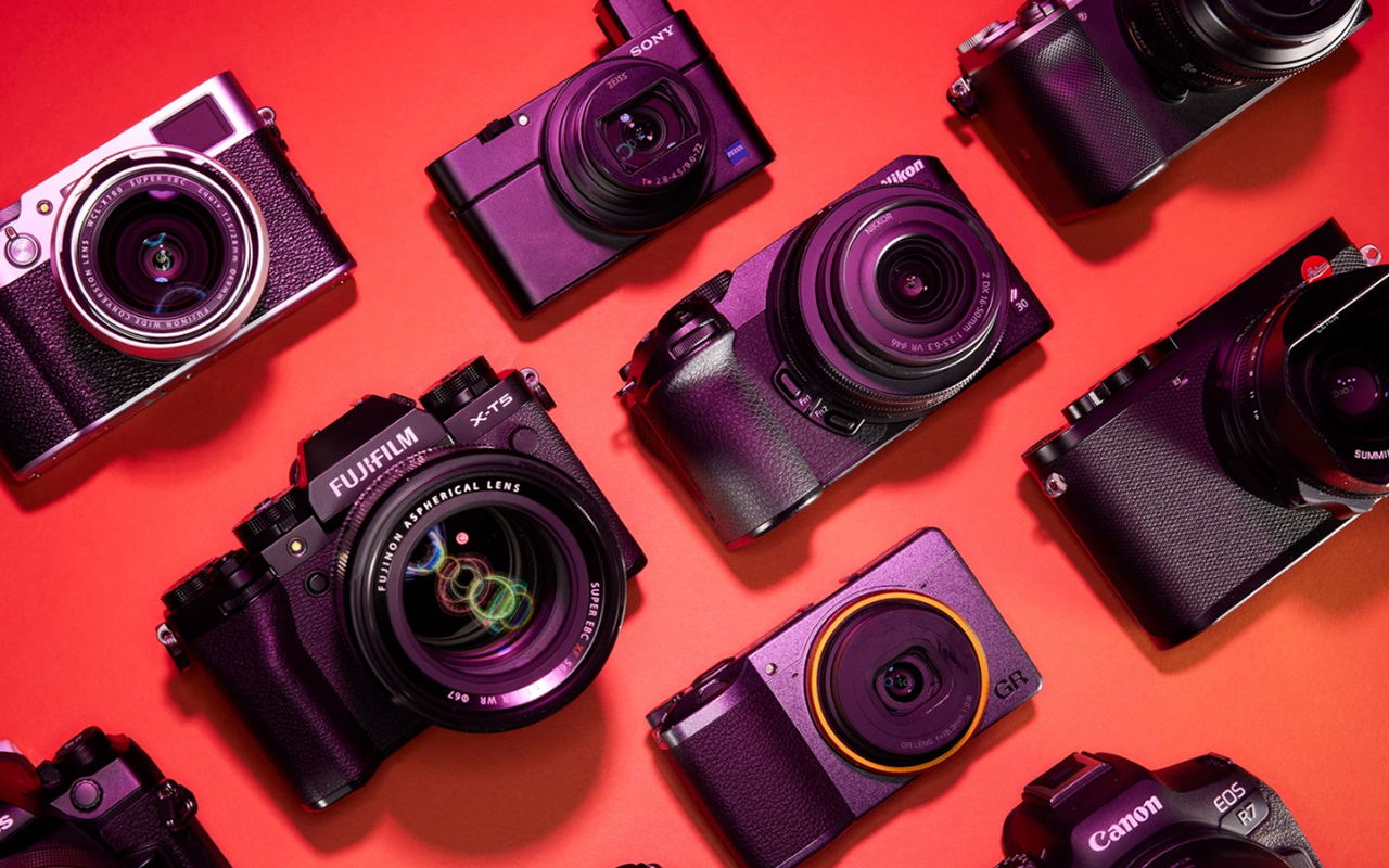 Studio photograph of a collection of cameras for the National Geographic 2023 travel camera guide.