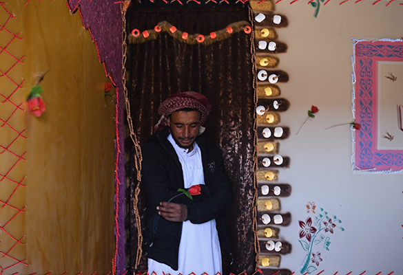 An embroidered photograph of Mahmoud Abdo in his home in Al Tarfa Village. His cousin Nora Mohamed embroidered the image.