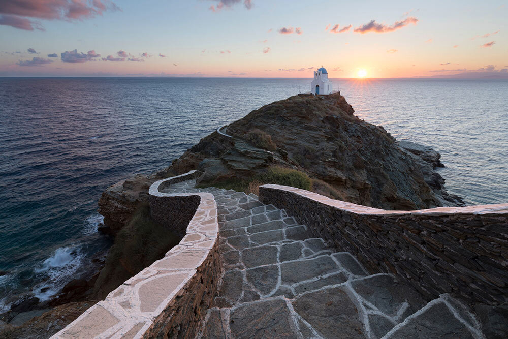 From the village of Kastro, a stone path leads down to Eftamartyres church, one of many picturesque sites travelers will find near the restored Sifnos Trails, on the island of Sifnos, Greece