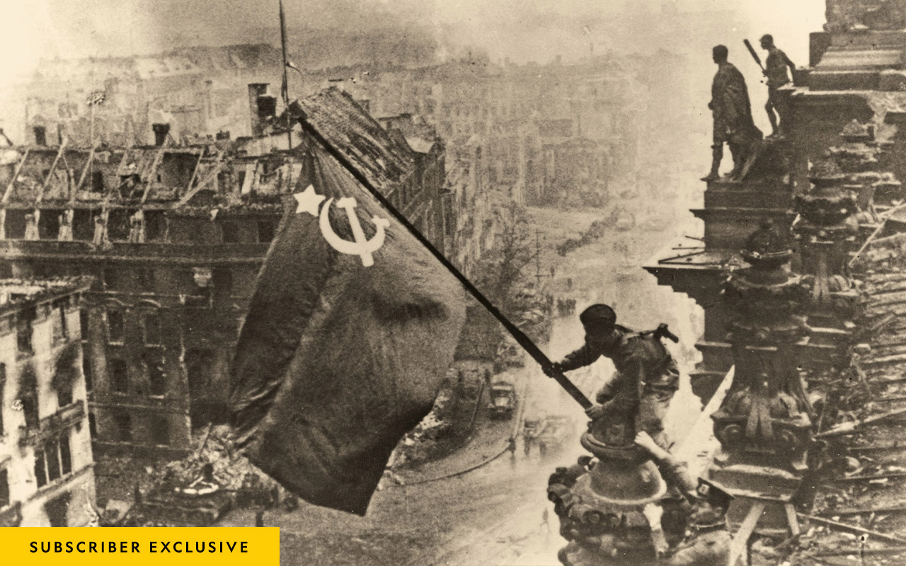 In one of the war’s most iconic images, Soviet soldiers raise their flag over the ruins of the Reichstag, Berlin, on May 2, 1945.