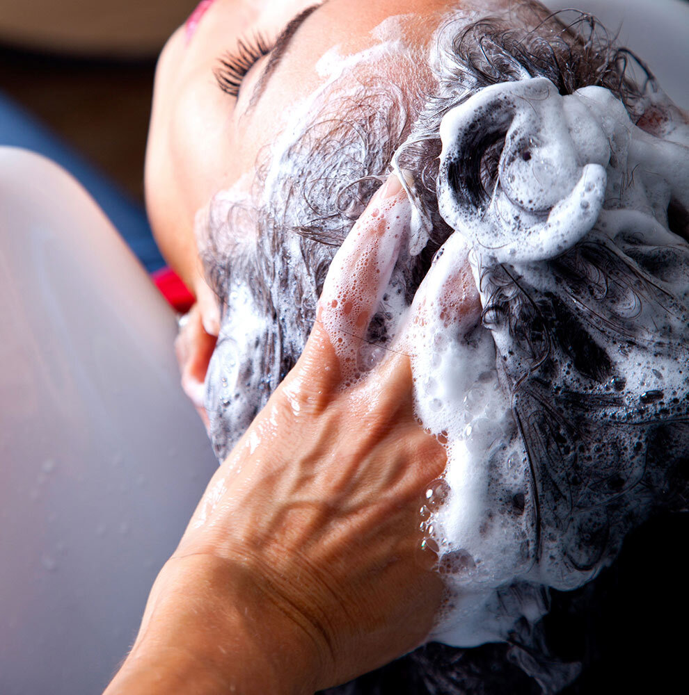 a woman getting her hair washed