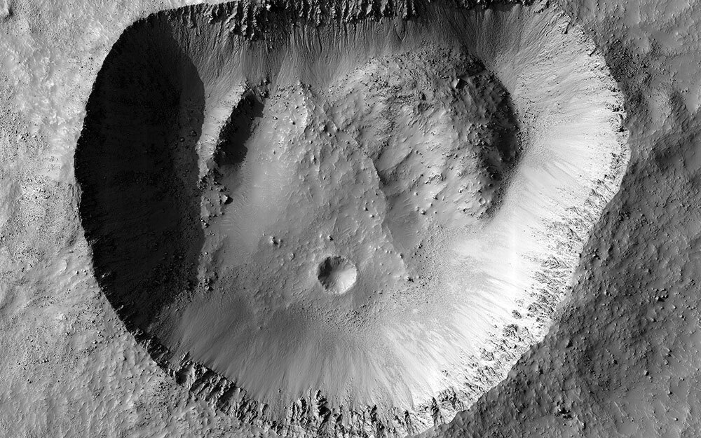 A black and white picture of a crater on Mars