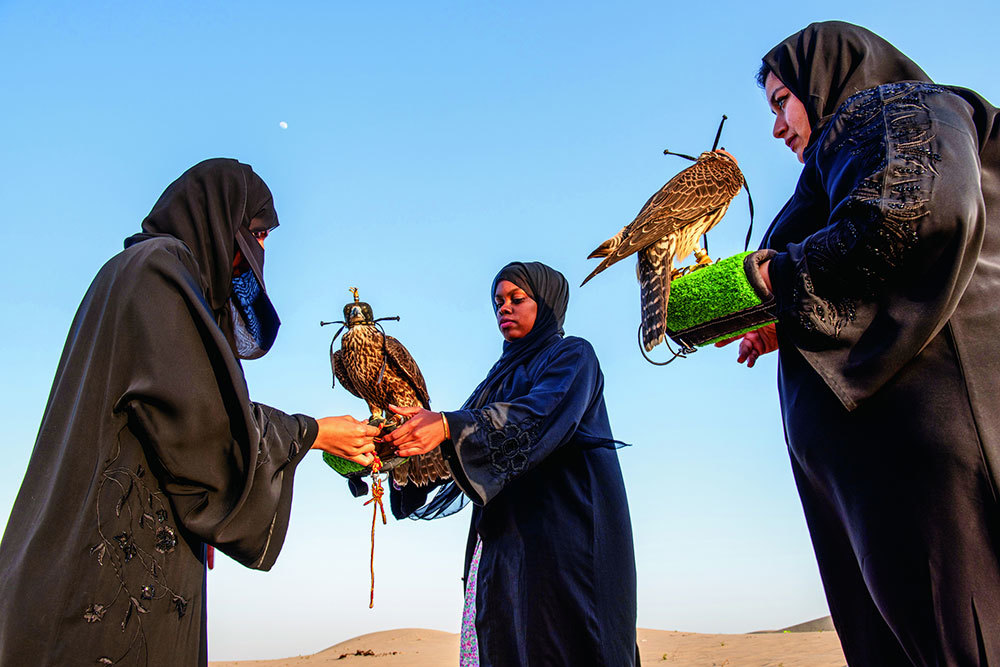 Three women falconers in Abu Dhabi