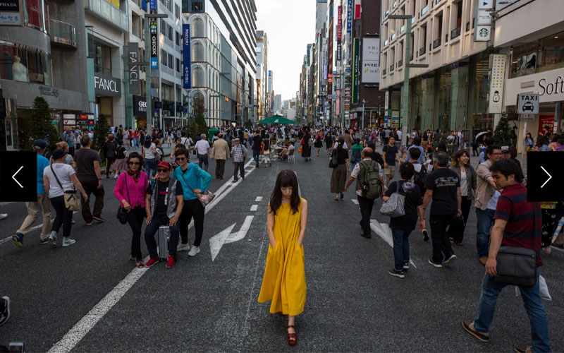 Pedestrians, shoppers, and people-watchers stroll on Chuo-dori in Ginza, one of Tokyo’s busiest destinations. 