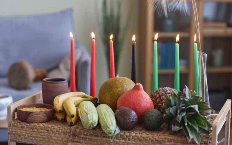 Symbols of African heritage are placed on traditional woven mats during Kwanzaa.