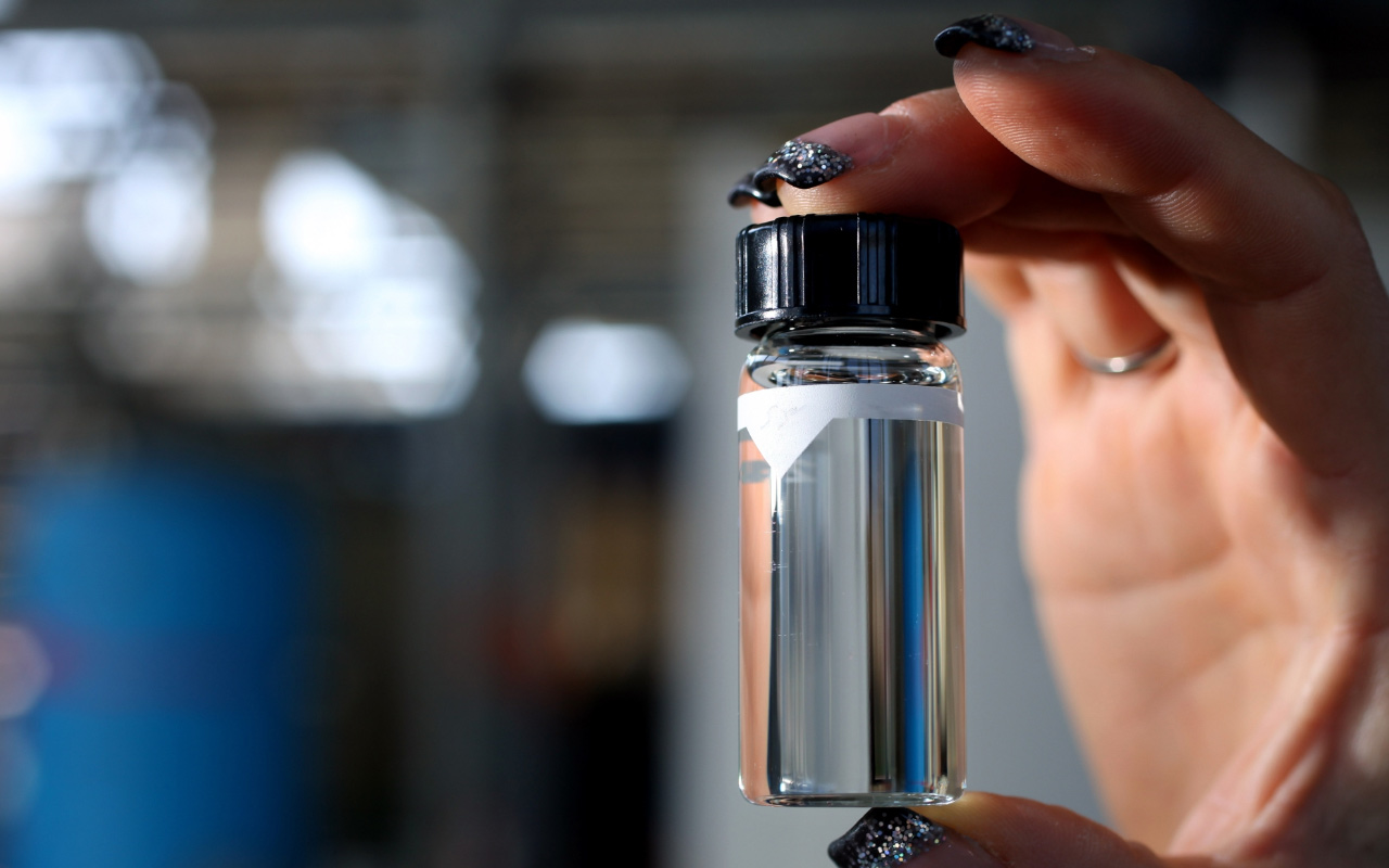 Person holding a clear tube filled with tap water