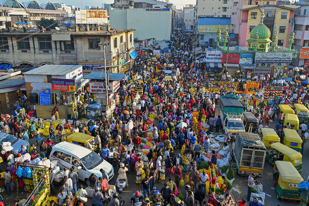 Many people shop at an outdoor market in India