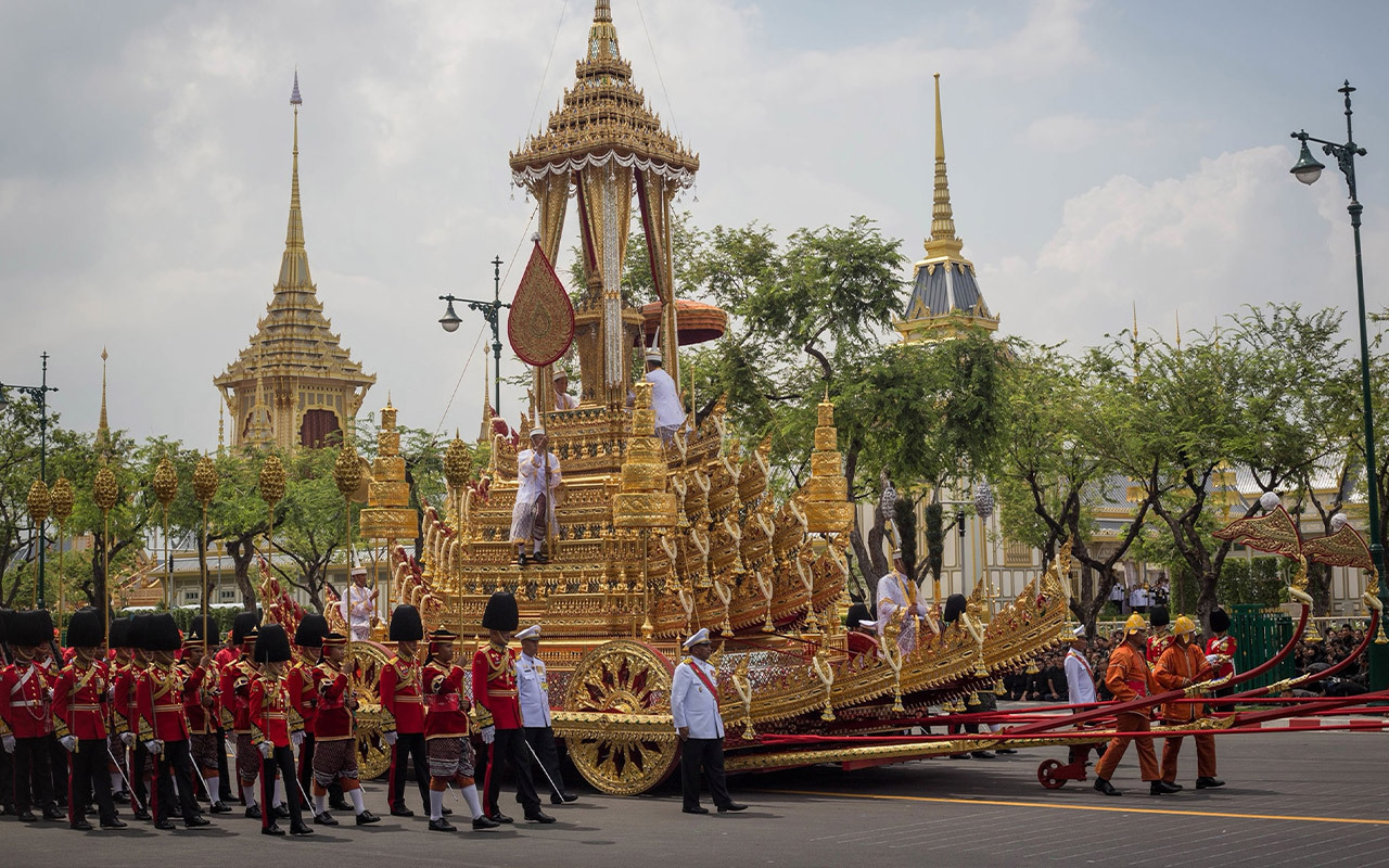 An urn symbolizing the late King Bhumibol Adulyadej’s remains is carried in an ornate golden chariot. The beloved king reigned over Thailand for 70 years, making him the world’s longest-reigning monarch upon his death.