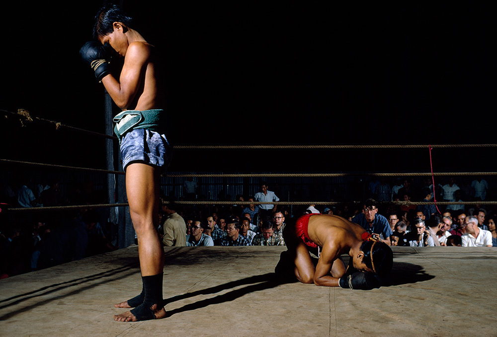 Two boxers pray in the ring