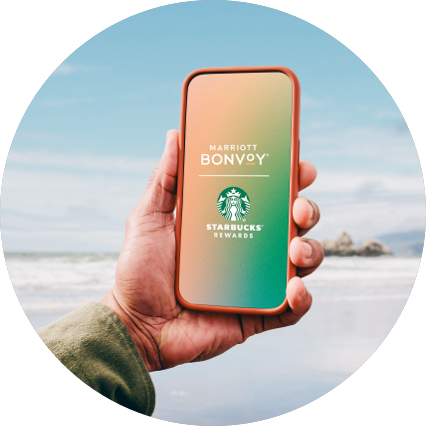 Mobile phone displaying the Marriott Bonvoy and Starbucks logo.