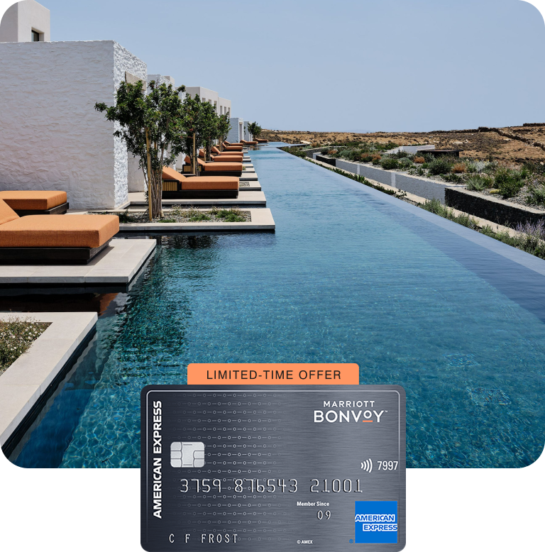 A row of lounges along a river-like swimming pool at a beachfront island resort in Tinos, Greece.