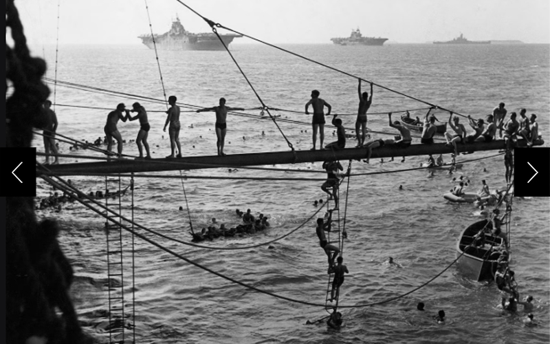 Crewmen of a U.S. Navy aircraft play in the water after a big naval battle.