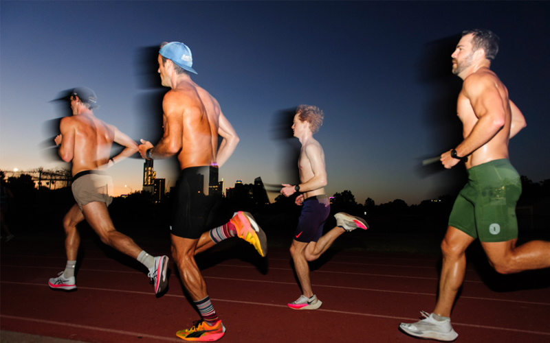 Four men run on a track.