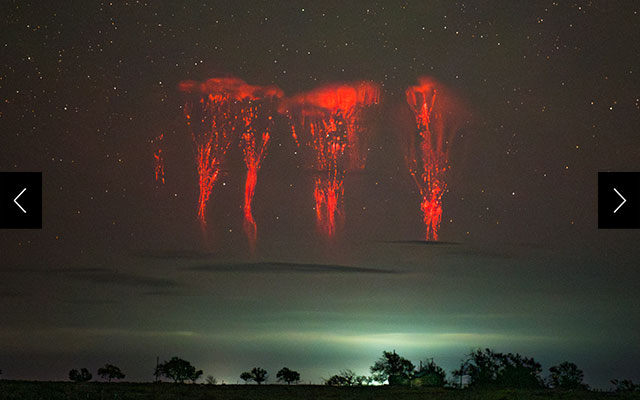 Red sprites, a type of transient luminous event or TLE, appear in the upper atmosphere above a thunderstorm in Oklahoma in April 2025.