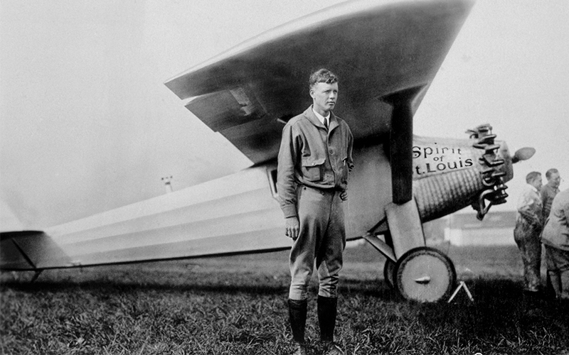 Charles Lindbergh standing in front of his plane, the Spirit of St. Louis, which he used on his transatlantic flight.