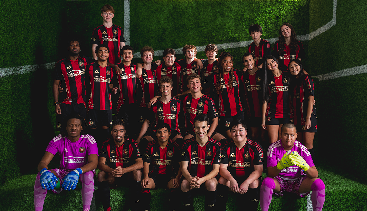 Atlanta Unified first team poses together in 2026 home kits on an indoor turf set