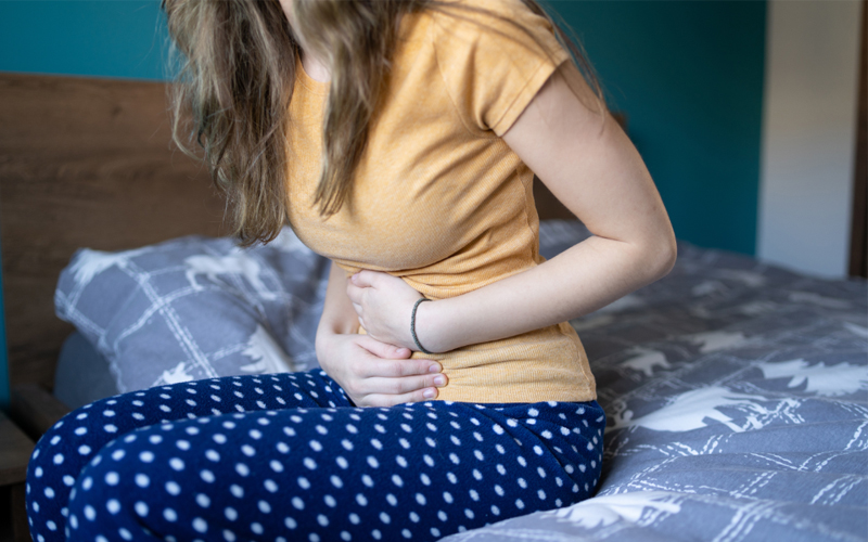 A woman holding her stomach.