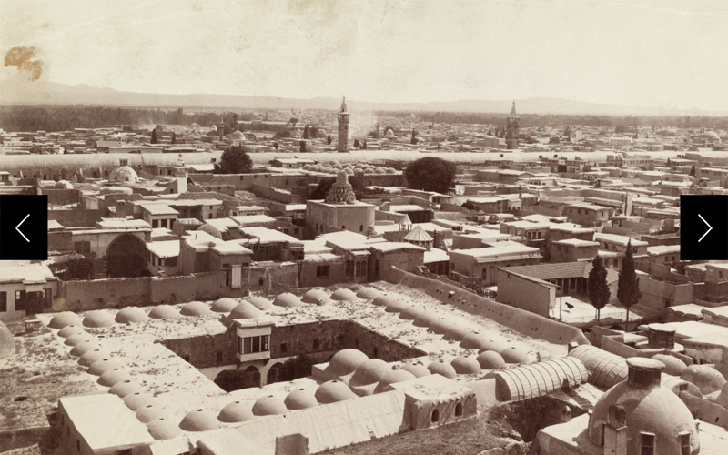 A rooftop view of domes, minarets, and two story caravansaries in Damascus, Syria in 1911. 