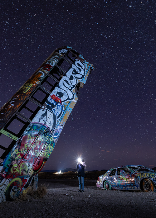 The International Car Forest of the Last Church in Goldfield, Nevada is not your typical forest—instead of leafy trees reaching skyward, dozens of colorfully painted, graffiti-covered automobiles stand dramatically in the desert soil.