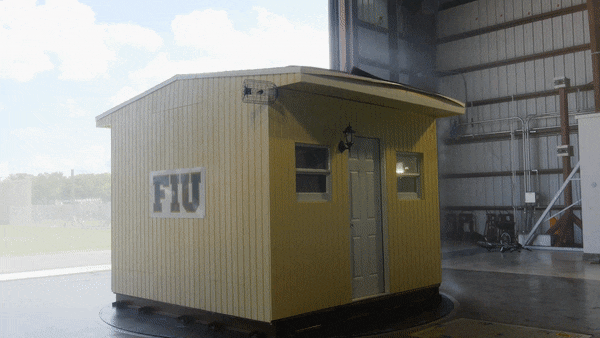 Winds blowing at 140 mph tear the walls and roof of a model home as part of an experiment at Florida International University's "Wall of Wind" facility.