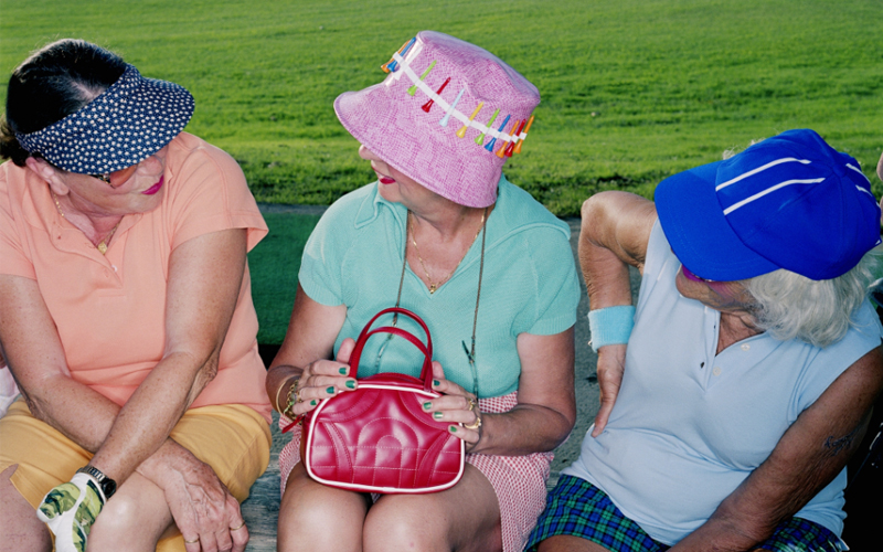 A group of older women on a bench.