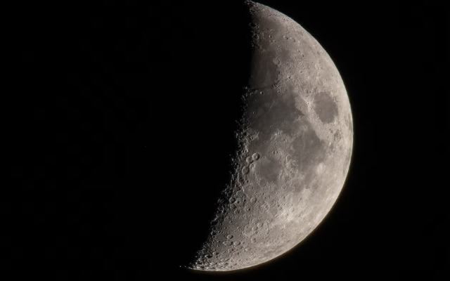 Part of the moon visible at night.