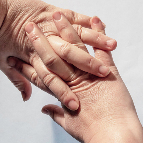 A pair of outstretched hands with interlocking fingers bent back to crack the knuckles