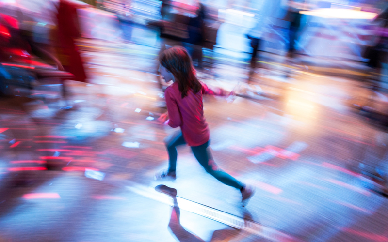 A young girl is pictured running in a blur. 