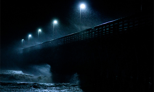 Waves crash into a pier as Hurricane Florence makes landfall in Myrtle Beach, South Carolina on September 14, 2018. The storm has been used as an example of why only heeding a hurricane's category is dangerous. Though it struck the coast as a Category 1 storm, Hurricane Florence caused devastating floods.