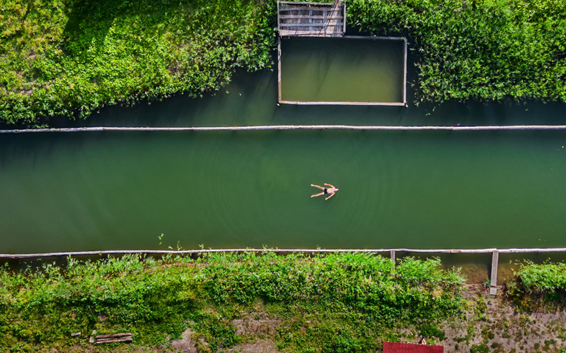 A villager floats in a natural pool.