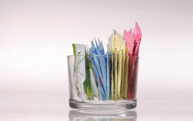 A cup of artificial and plant-based sweeteners. 