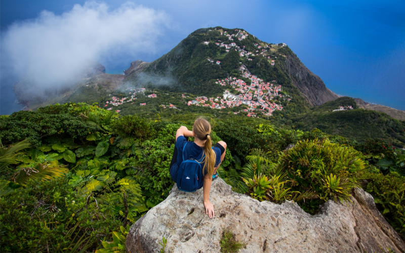 An image of a hiker on top of a mountain