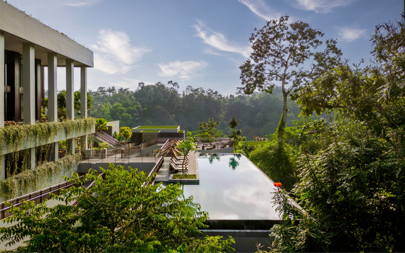 Anantara Ubud Bali Resort features a floating pool near a jungle landscape.