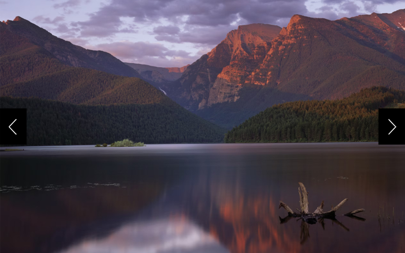 Mountains are reflected in a lake in the Mission Mountains Tribal Wilderness.