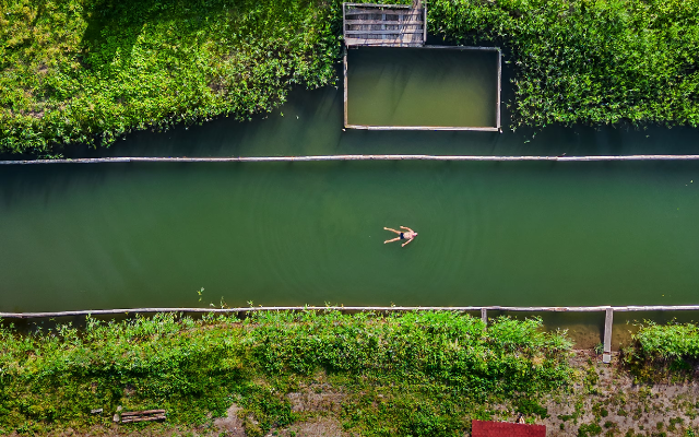 A villager floats in a natural pool. 