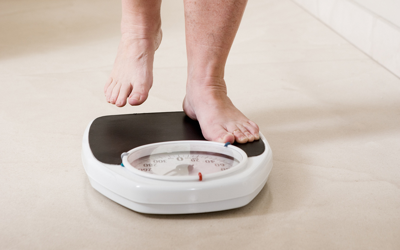 A person stands on a scale