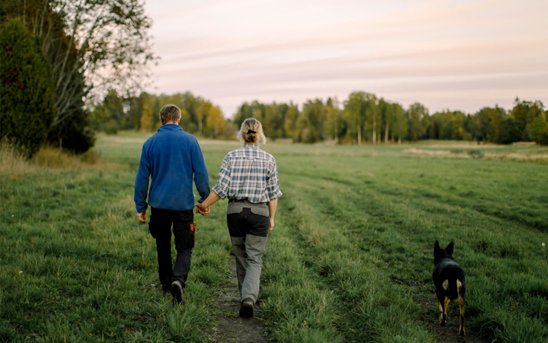 A couple takes a sunset stroll. 