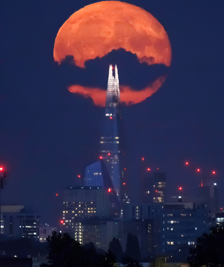 A near full “sturgeon moon” rises behind The Shard in central London on August 20, 2024.