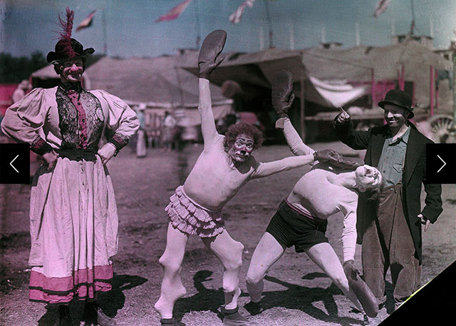 Two clowns engage in burlesque boxing while a clown referee and female impersonator look on.