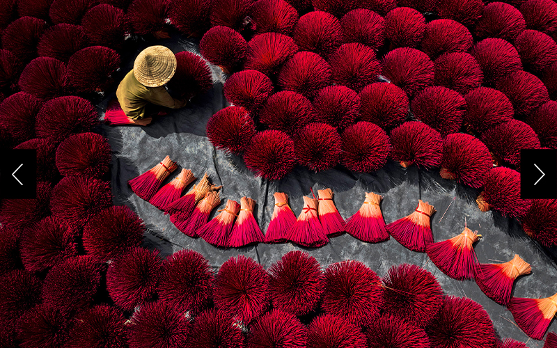 In Hanoi, a woman dries incense for people to pay respect to their ancestors.